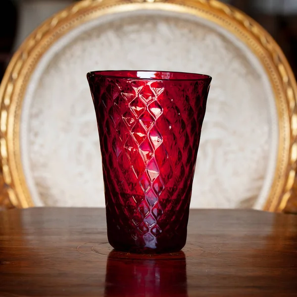 antique red glass flower vase in the interior. vase for flowers in luxury interior. luxury vase