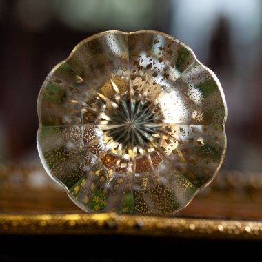glass antique green vase in luxury interior. crystal vase with gold painting close-up. bohemian glass closeup