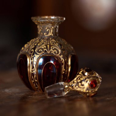 antique perfume bottle in luxury interior. crystal bottle with a golden pattern. bohemian glass closeup