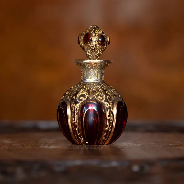 antique perfume bottle in luxury interior. crystal bottle with a golden pattern. bohemian glass closeup
