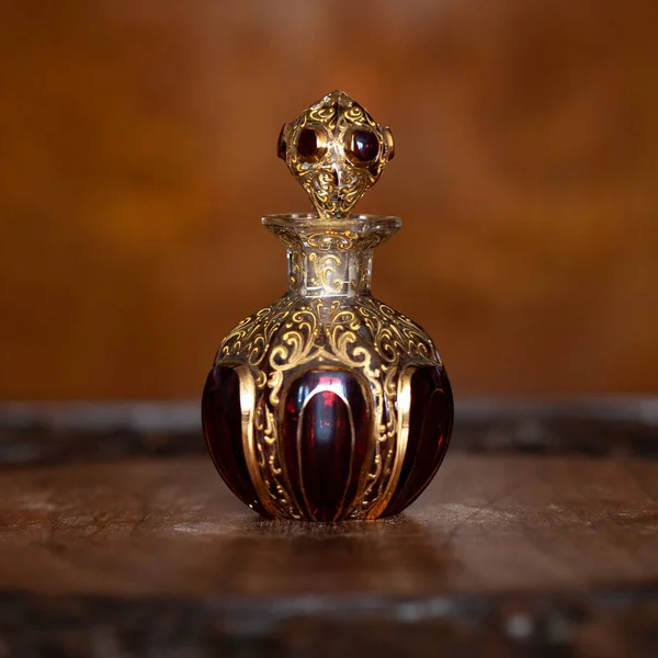 antique perfume bottle in luxury interior. crystal bottle with a golden pattern. bohemian glass closeup