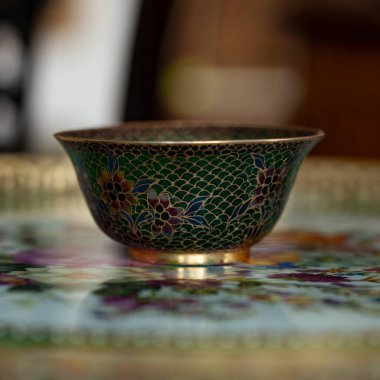 stained glass dish in a luxurious interior. crystal green plate with floral pattern. bohemian glass closeup