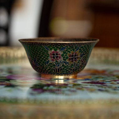 stained glass dish in a luxurious interior. crystal green plate with floral pattern. bohemian glass closeup