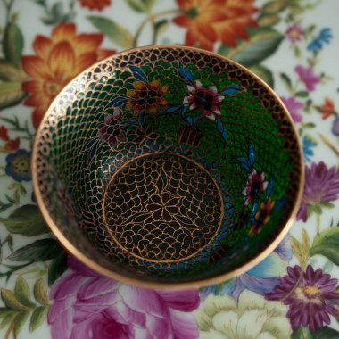 stained glass dish in a luxurious interior. crystal green plate with floral pattern. bohemian glass closeup