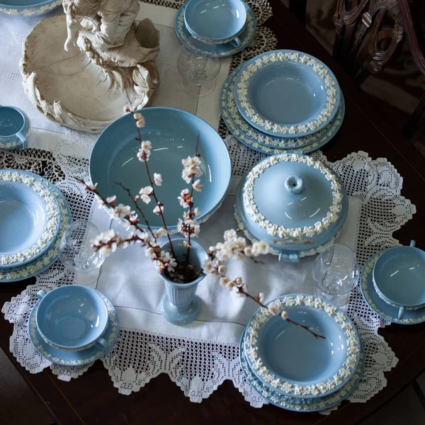 Antique British blue porcelain tea set.wedding table setting is richly decorated in luxurious interior. porcelain vintage service