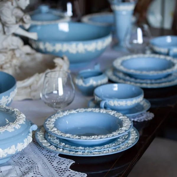 Antique British blue porcelain tea set.wedding table setting is richly decorated in luxurious interior. porcelain vintage service