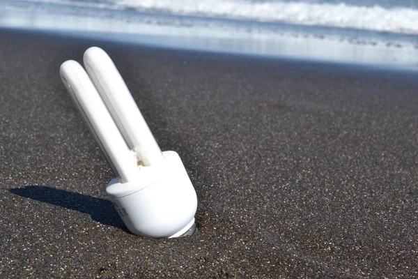 White bulb in the sand — Stock Photo, Image