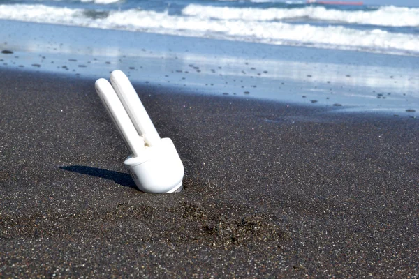 White bulb in the sand — Stock Photo, Image