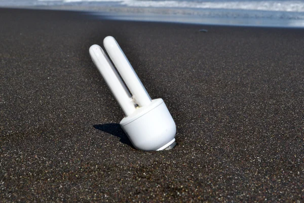 White bulb in the sand — Stock Photo, Image