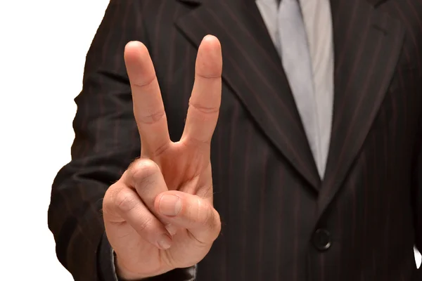 Businessman showing fingers in victory — Stock Photo, Image