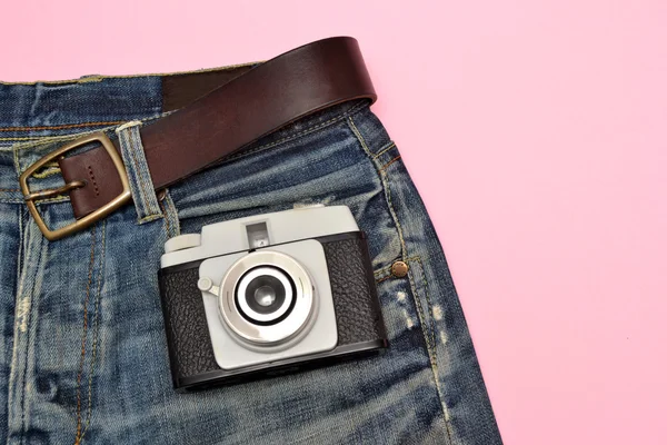 Jeans and old photo camera — Stock Photo, Image