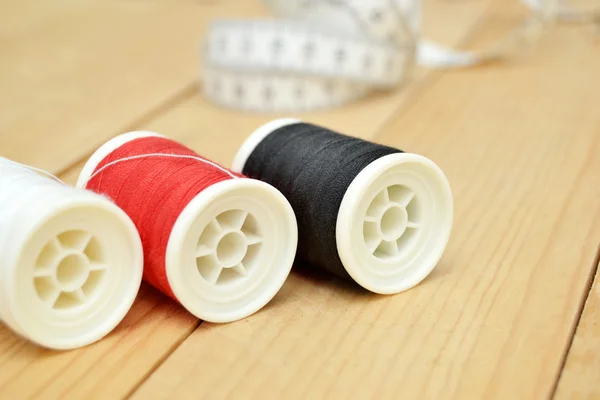 Sewing threads on wood — Stock Photo, Image