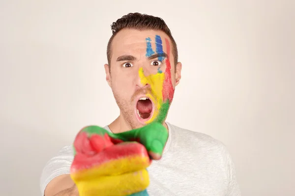 Man pointing at the camera with his eyes and face painted — Stock Photo, Image