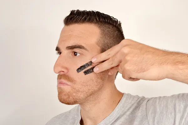 Man with painted face of war — Stock Photo, Image