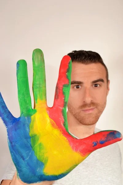 Young man with hand at stop sign — Stock Photo, Image