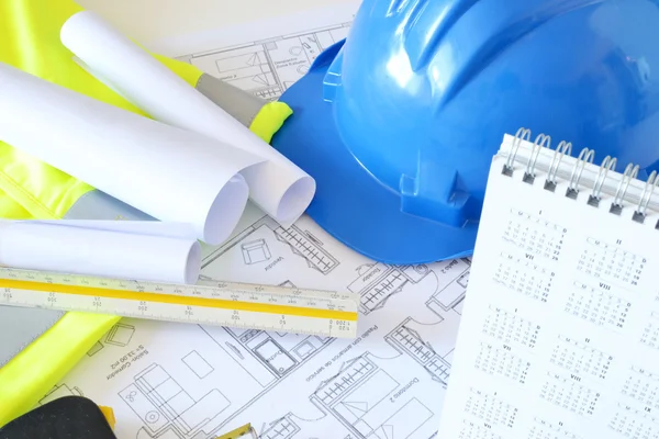 Helmet and tools for construction drawings — Stock Photo, Image