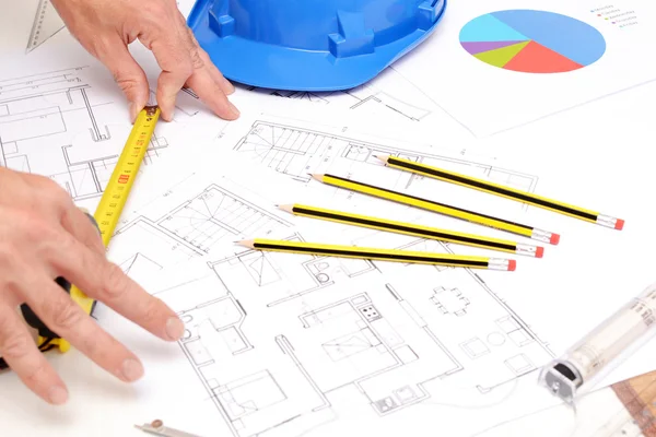 Helmet and tools for construction drawings — Stock Photo, Image