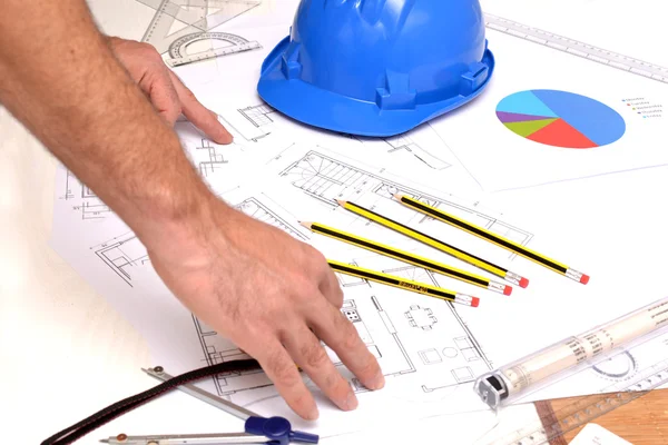 Helmet and tools for construction drawings — Stock Photo, Image