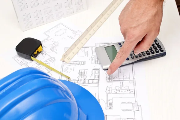 Helmet and tools for construction drawings — Stock Photo, Image