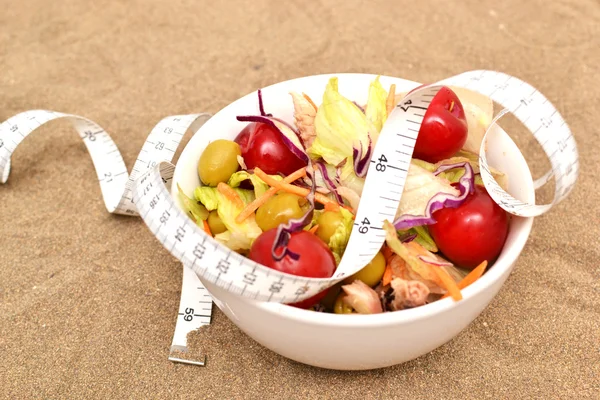 Salad and tape measure — Stock Photo, Image