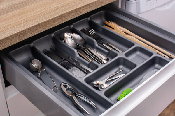 Drawer with cutlery in kitchen