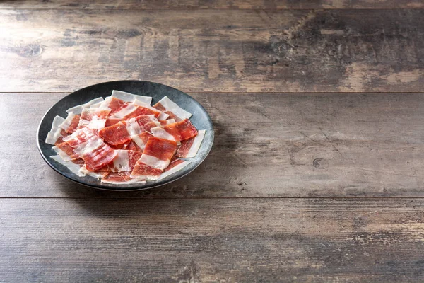 Spanish Serrano Ham Slices Black Plate Wooden Table Copy Space — Fotografia de Stock