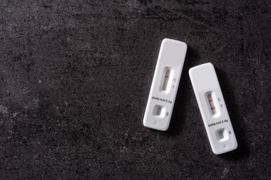 Covid-19 rapid antigen test on black stone background. Copy space