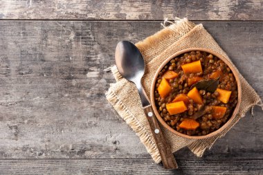 Balkabaklı mercimek yahnisi ve tahta masada havuç. Üst Manzara. Boşluğu kopyala