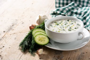 Bulgar taratör, ahşap masada kasede ekşi süt çorbası içiyor. Boşluğu kopyala