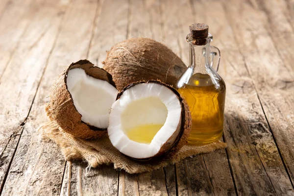 Sliced Coconuts Oil Bottle Coconut Oil Wooden Table — Stock Photo, Image