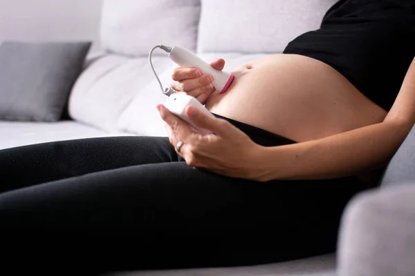 Pregnant Woman Fetal Doppler Listening Baby Heart Sitting Sofa Home — Stock Photo, Image