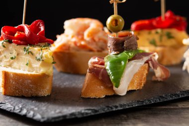 Ahşap masada İspanyol pintxos çeşitleri