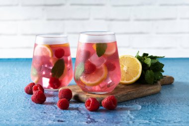 Raspberry lemonade drink on blue background