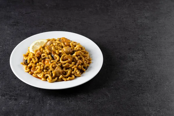 Traditional Spanish fideua. Noodle paella isolated on white background. Top  view Stock Photo - Alamy