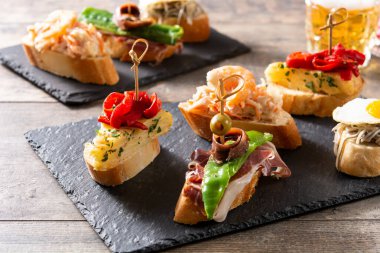 Ahşap masada İspanyol pintxos çeşitleri