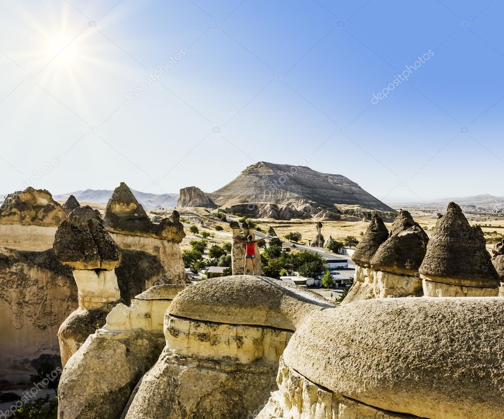 Girl posing on top of a cliff in Cappadocia, Turkey
