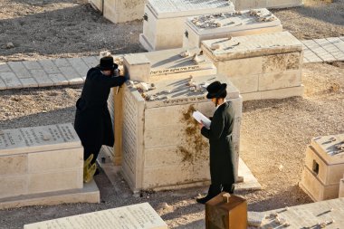 Jews pray at the graves of ancestors on the Mount of olives in Jerusalem clipart