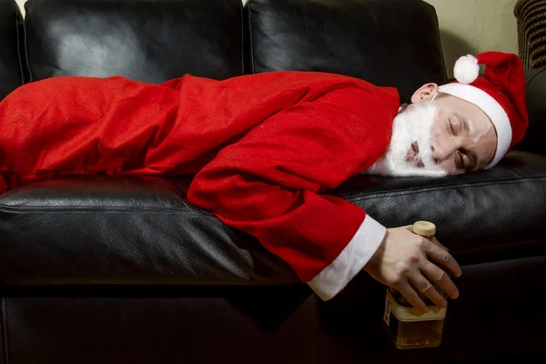 Sarhoş Noel Baba kılığında bir şişe viski ile — Stok fotoğraf