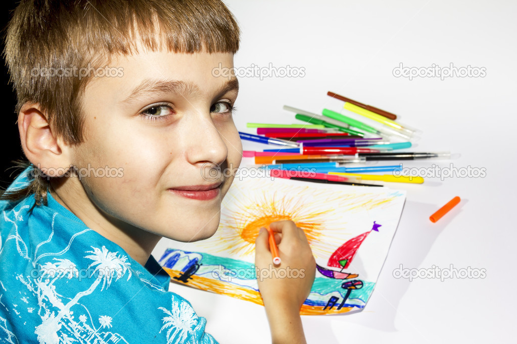 The boy draws a picture set of multicolored markers