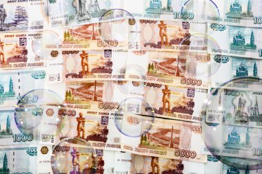 Bizi banknotlar fonunda sabun köpüğü
