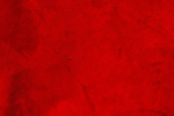 Red suede texture. Red matte background of suede. Velvet texture of seamless leather.