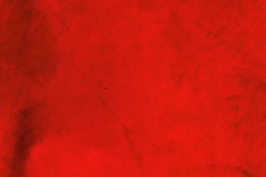Kırmızı süet kumaş. Süetin kırmızı mat arka planı. Pürüzsüz derinin kadife dokusu.