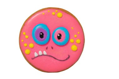 Happy Halloween and sweets. Gingerbread in the form of a pink monster.