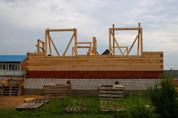 Unfinished, ecological wooden house and building area.