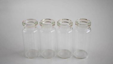 İlaç depolamak için boş cam şişeler, beyaz arka planda sıvılar..