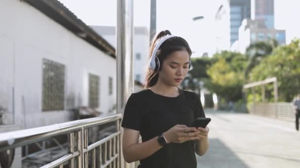Спортсмен Азії Бігає Навушниках Допомогою Смартфона Який Слухає Музику Стоячи — стокове відео