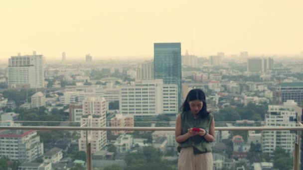 Asijské Žena Pomocí Smartphone Zatímco Stojí Střeše Budovy — Stock video