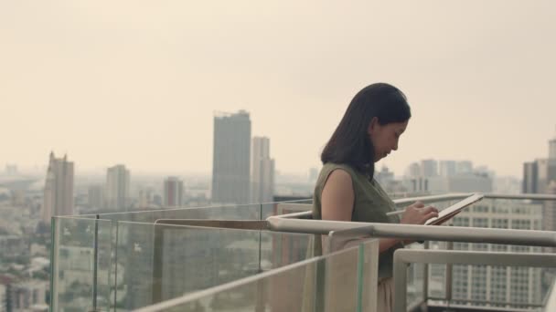 Attractive Woman Using Tablet Chatting Friends While Standing Balcony Rooftop — Stock Video