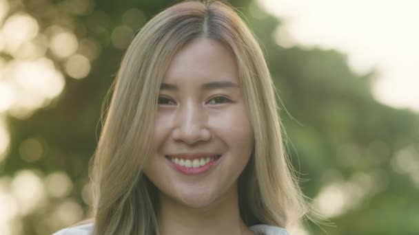 Gülümseyen Asyalı Kadın Mutlu Bir Şekilde Kameraya Bakıyor Gün Batımında — Stok video