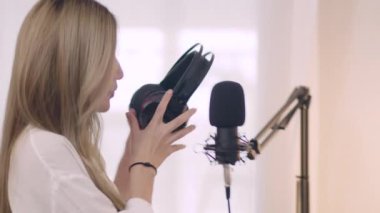 Genç Asyalı kadın podcaster 'ın yakın çekimleri podcast' i kaydediyor ve sosyal medya için ev stüdyosunda canlı yayın içeriği.